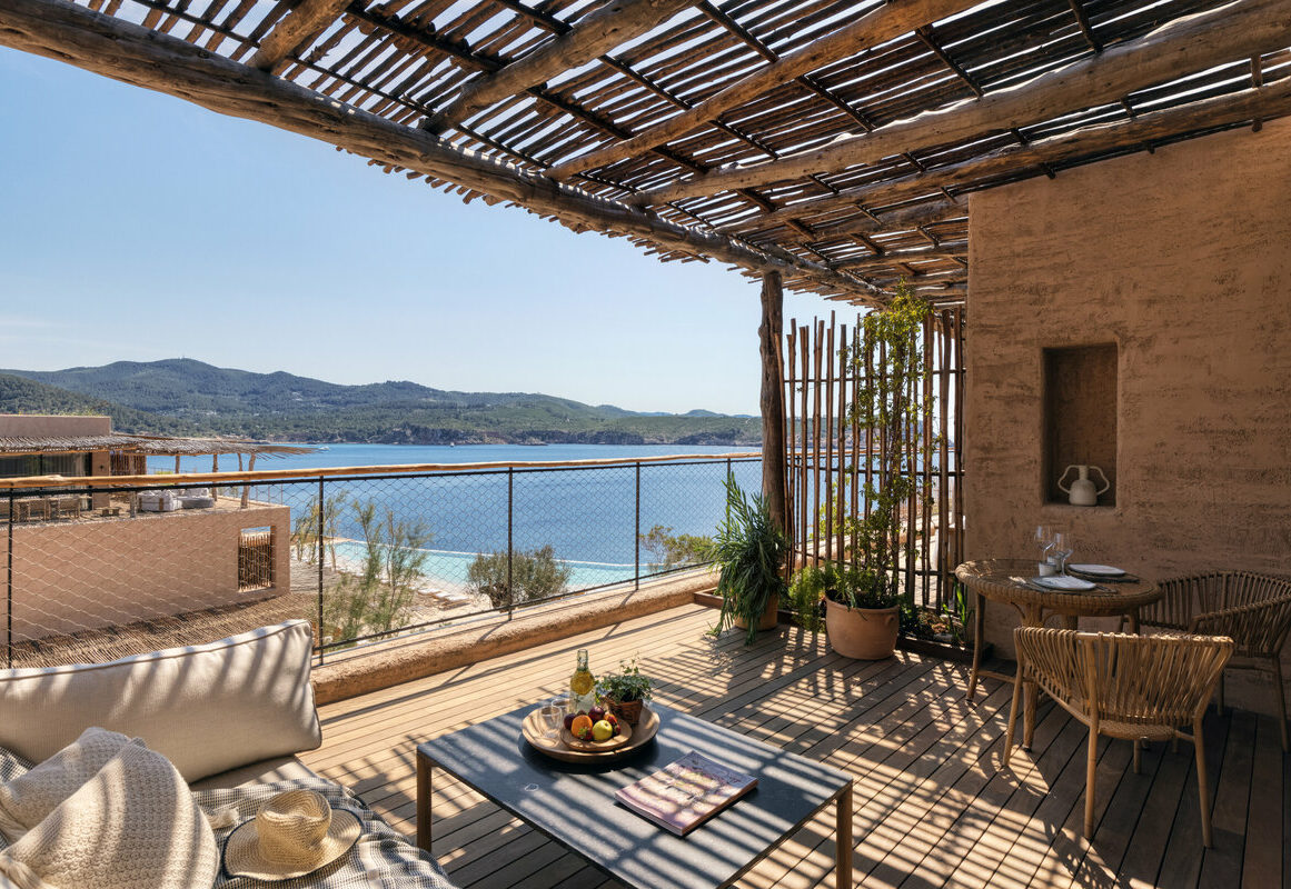 a deck with a view of the ocean and a beach