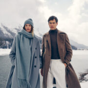 a man and woman in white clothes standing in snow